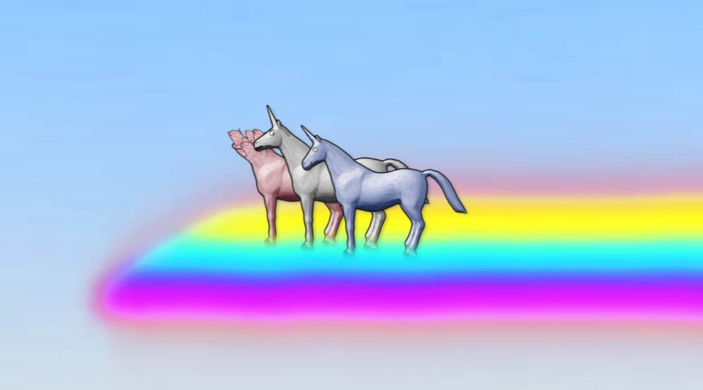 A pink unicorn and a blue-gray unicorn standing together on a bright rainbow against a pale blue sky